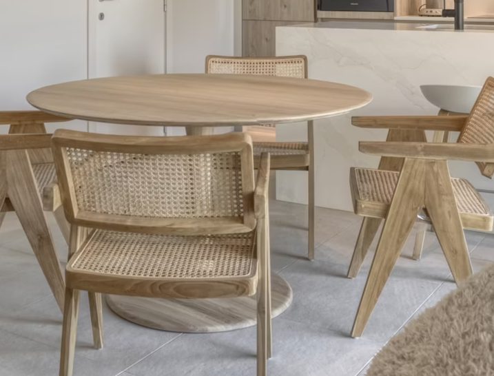Oak and cane dining chairs around a round table