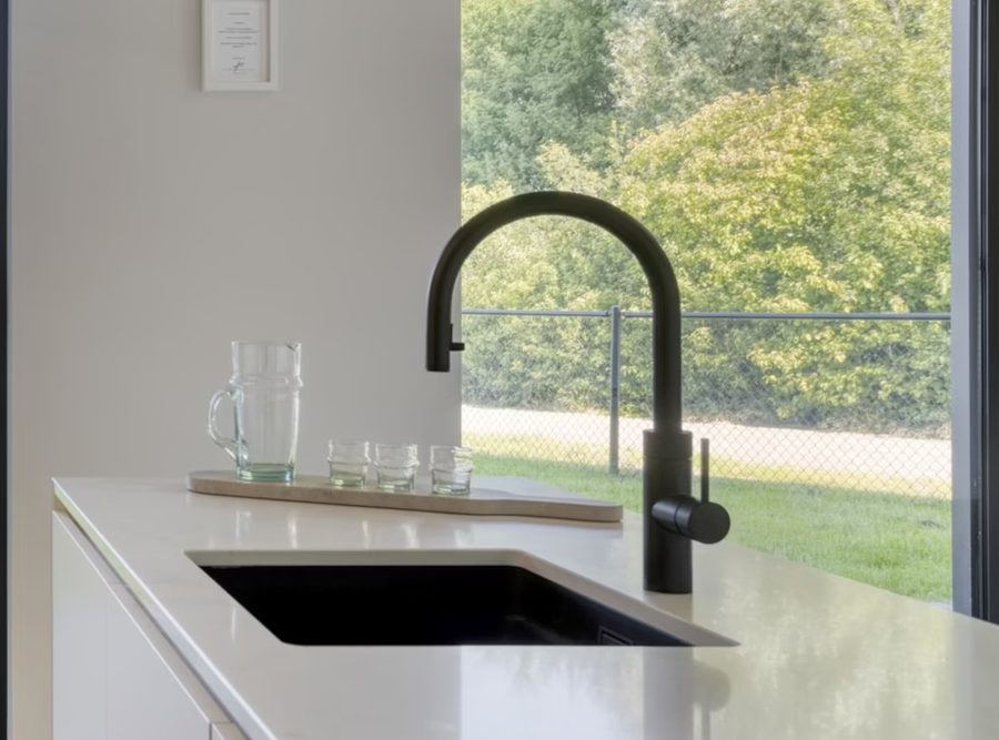 Black tap on a stone worktop